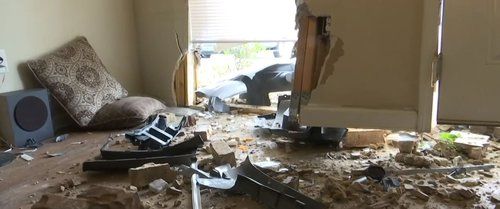 Car crashes into apartment building with two children inside